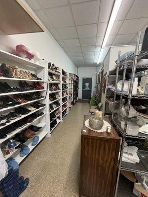 The shoe, game and book sections in the back of the store.