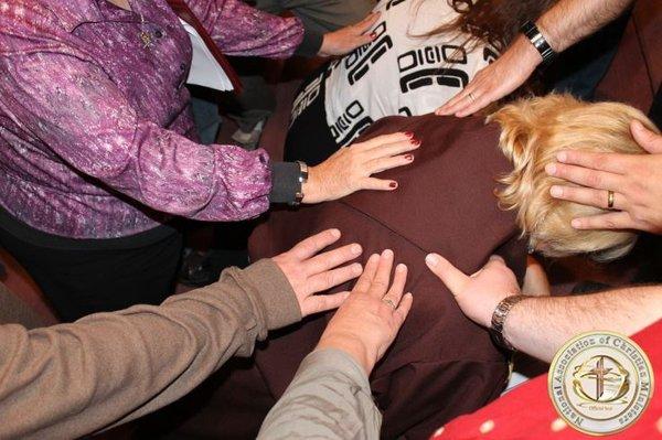 Receiving the laying on hands blessing.