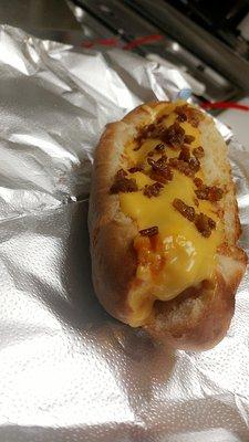 Chili cheese dog topped with bacon on our toasted custom made bread