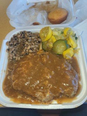 Smothered pork chop over rice, with blackeyed peas, and squash zucchini mix