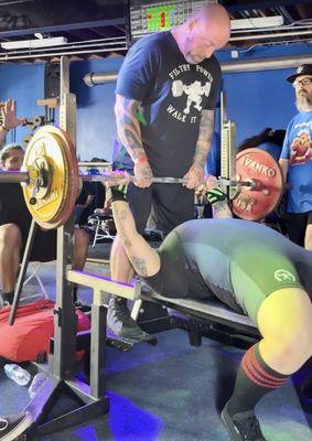 Reilly handing off for my bench press in my first powerlifting competition.