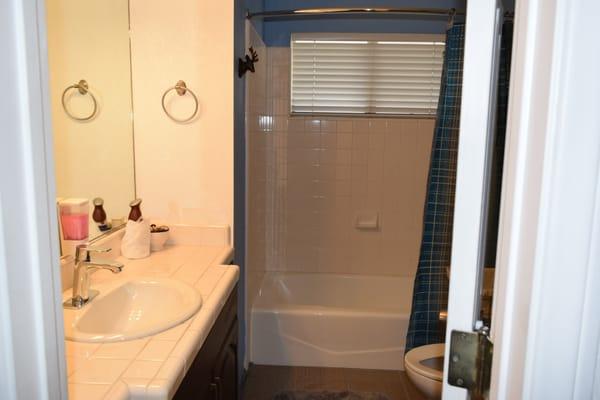 one of the 2 bathrooms w/ complimentary handsoap, shampoo, conditioner, bodywash and hairdryer