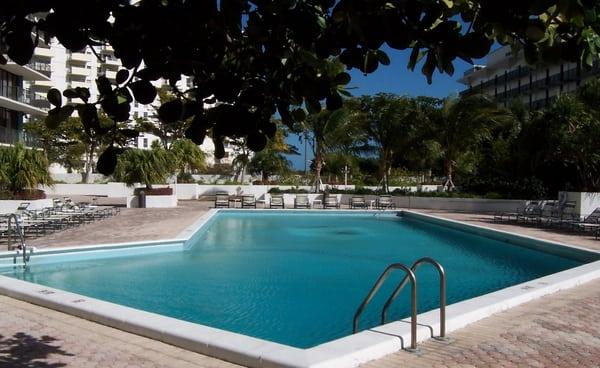 THE PALM BAY YACHT CLUB CONDO AND ITS GRAND POOL WITH LUSH LANDSCAPING