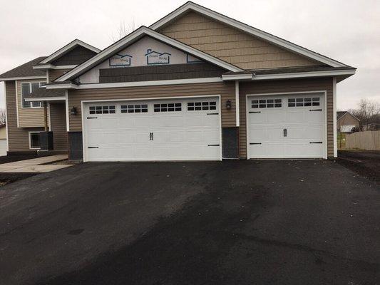 Carriage style garage doors add nice charm to the home