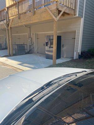 Left refrigerator on driveway pavement