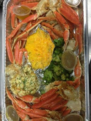 Crab legs, twice bake seafood potato, steamed vegetables and seafood Mac and cheese