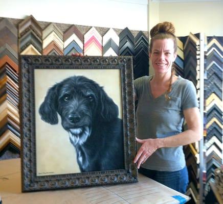 Denise Wilkins holding a newly framed painting. Turned out perfectly!