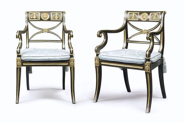 A pair of Regency period faux ebony and gilt armchairs