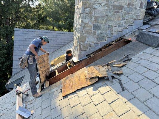 Slate roof leak repair on stone chimney