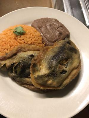 Stuffed pepper served with rice and beans