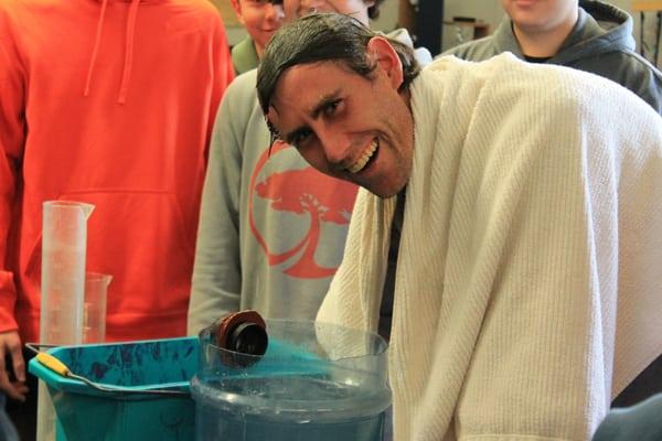 Mount Elden Middle School Alpine Academy teachers lead students in a water displacement experiment.