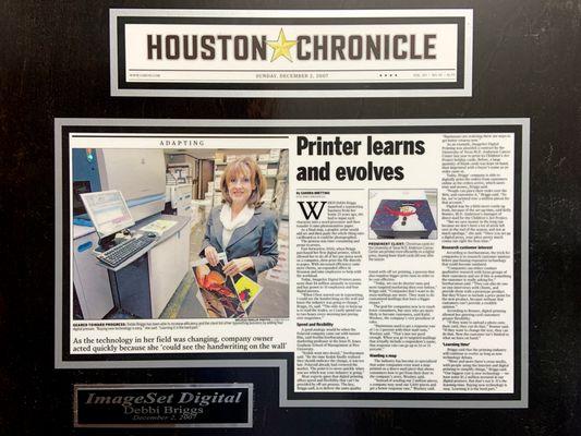 Plaque showcasing our feature in the Houston Chronicle article 'Printer Learns and Evolves,' highlighting our journey in print services.