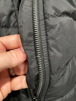 Damaged zipper on the jacket.