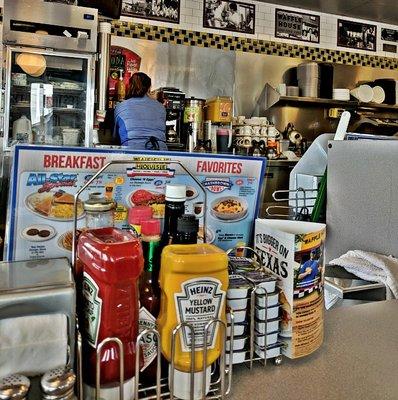 Sitting at the counter looking in on the work stations for food prep work. Everyone stayed busy