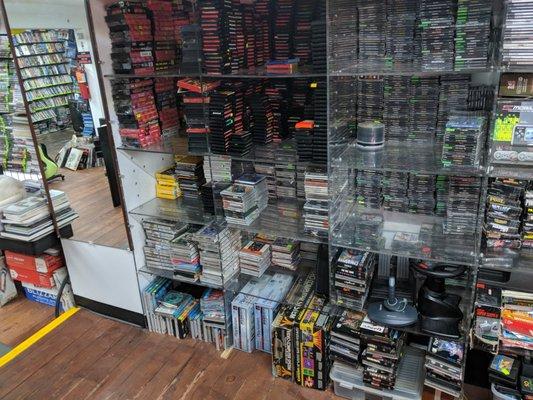 Just one of many walls of console games, this one showing Genesis, Sega CD, Dreamcast, and PS1 games. Also consoles in boxes at the bottom!