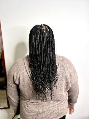 Medium knotless braids with wavy ends.