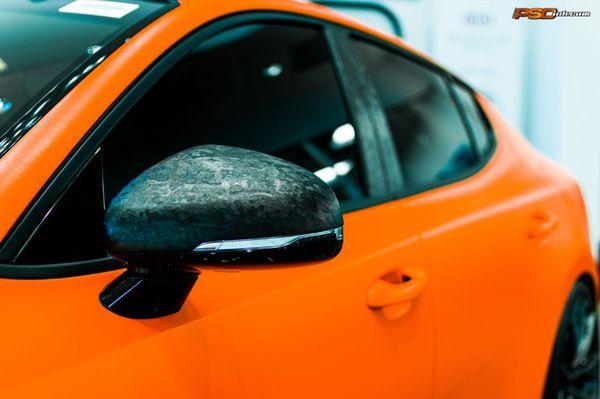 Matte orange Kia Stinger with Forged Carbon Fiber accents.