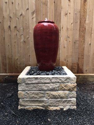 Installed natural stone around new water fountain jug.