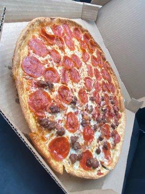 A large pizza with bacon, cheese, and pepperoni