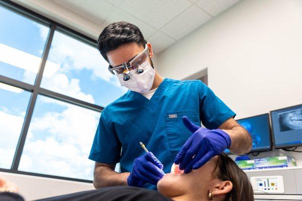 Dr. Siddiqui treating a patient during their visit at Advanced Family Dental of Midlothian