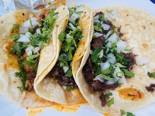 Barbacoa And el pastor tacos on flour.