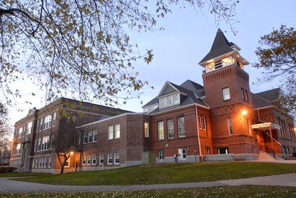 Thornton Academy's main building at dusk.