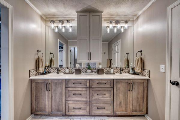 Evoke cabinetry topped with countertops and sink by Onxy Collection and Stone Peak Florentina backsplash.