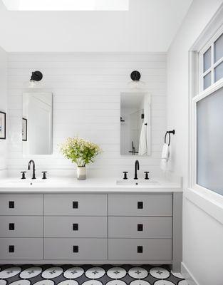 Girl's bathroom with concrete tile floor and gray cabinets