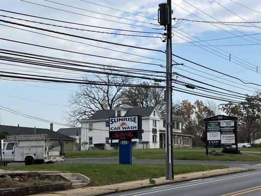 Street view. Signage is located between 2 entranceways. Enter the driveway where the car wash is located. Officers are in the rear.