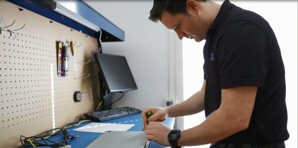 Kyle fixing a Macbook Pro