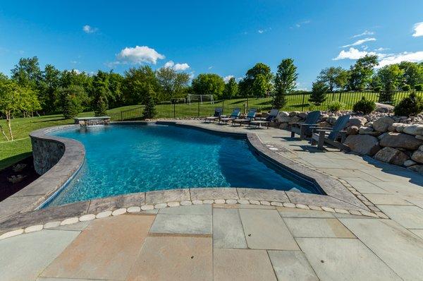 A custom in-ground gunite swimming pool designed and built by Precision Pool and Spa.