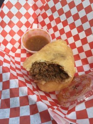 The sausage fried pie with Hot Trini sauce