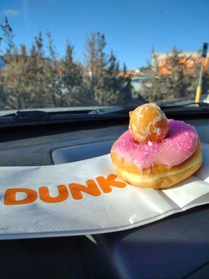 Strawberry donut with sprinkles and a donut hole