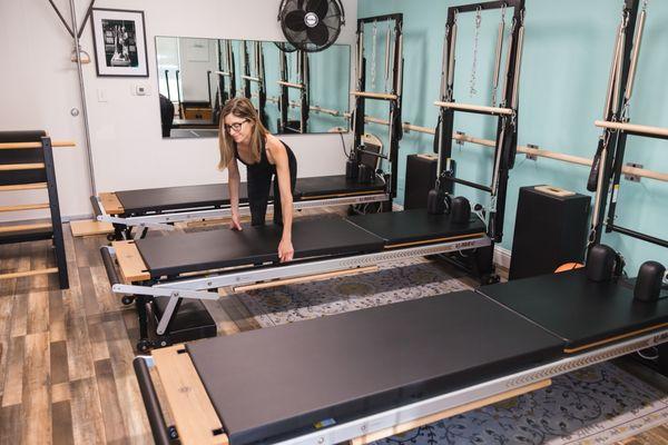 Setting up for a Pilates Mat class and Tower class.