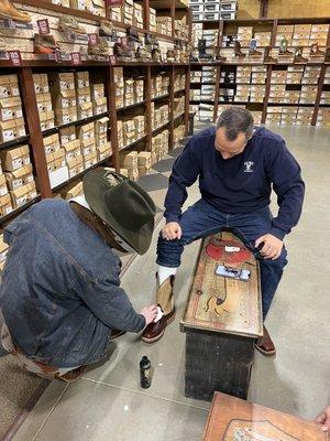 Tyson putting conditioner on the boots