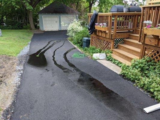 Runoff from roof and driveway being directed right toward yard instead of left toward property edge.