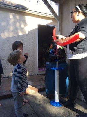 Teresa from Madcap Balloons making a light saber.