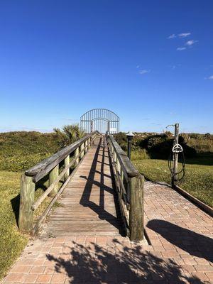 Gated access to the beach with a shower and trash can for your convenience