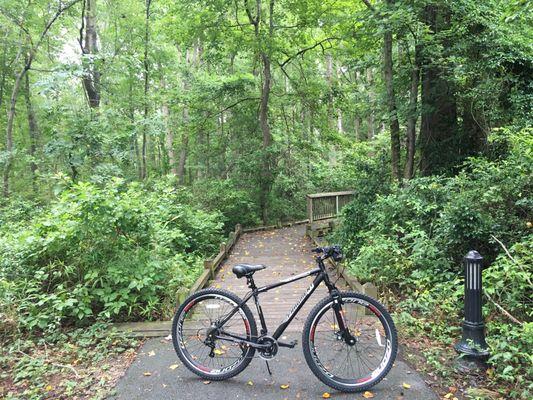 my bike in front of a wooden bridge that goes through doko meadows