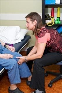 Gina working with a patient with a knee problem