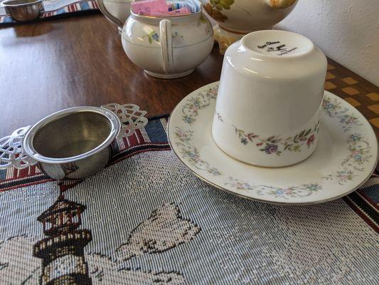 The metal strainer goes over your cup to strain out the tea leaves when you pour tea into your cup.