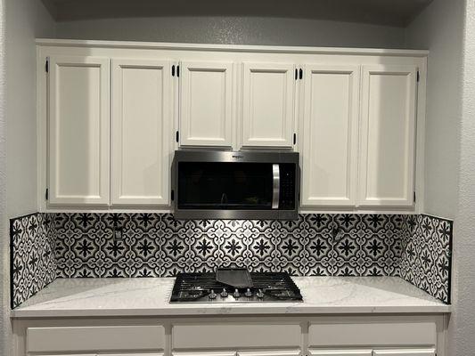 Updated kitchen.  Painted cabinets, New Quartz countertops, and tile backsplash.