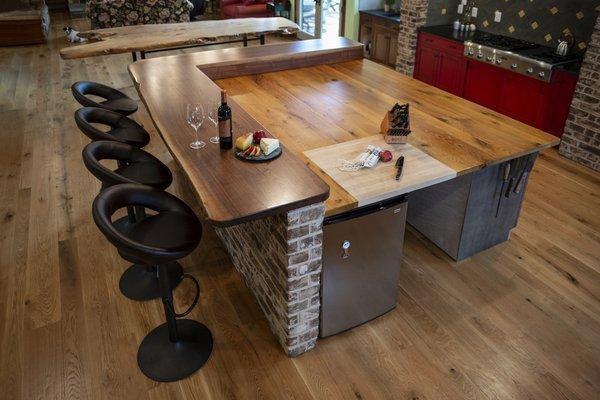 walnut bar surrounding oak kitchen island with cutting board