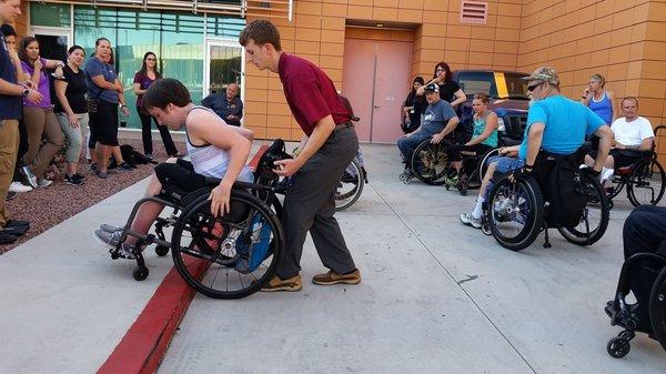 Assisting a chair user up a curb