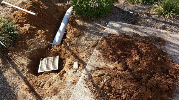 Drain install with river rock