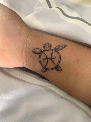 This is a turtle tattoo with my zodiac symbol in the shell(Pisces)