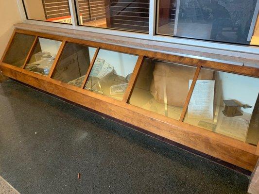 Exhibit case with old photos and postage medals.