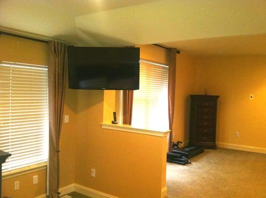 46" Samsung TV on a Peerless articulating mount allows viewing from the bed, as seen here, or rotated to the sitting area.