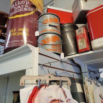 More antiques on shelves running along ceiling.