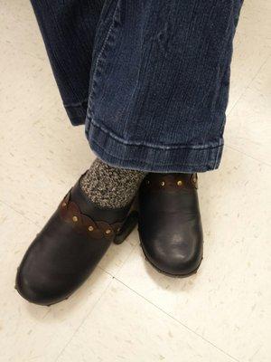 My wife trying on a pair of navy blue Natural Soul shoes at Marshalls.